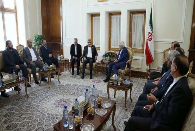 Iran’s Foreign Minister Mohammad Javad Zarif (C-R) and a member of Hamas’ political bureau, Izzat al-Rishq (C-L), meet in Tehran on August 7, 2017.
