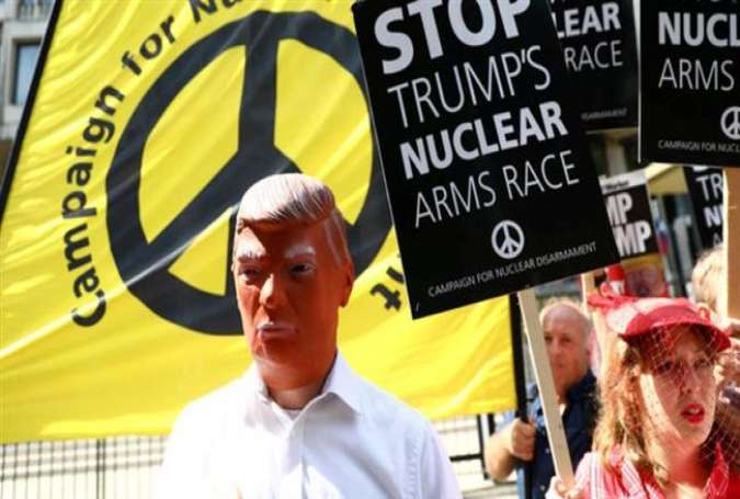 An anti-war protester is seen in a Donald Trump mask in London.jpg