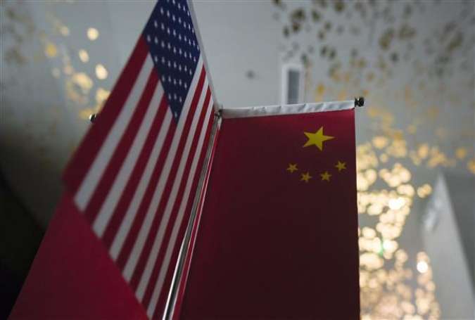 Chinese and American flags are displayed in a company in Beijing on August 16, 2017 amid rising Trade tensions between the United States and China. (Photo by AFP)