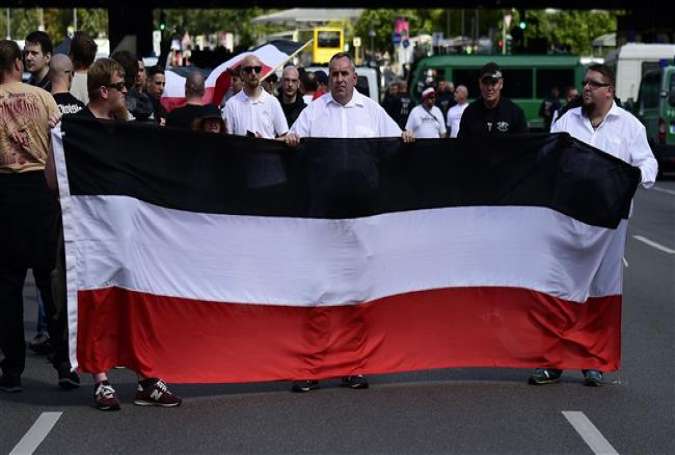 Extreme right-wing demonstrators gather prior to a neo-Nazi rally on the occasion of the 30th anniversary of the death of Hitler