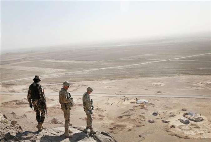 Two American soldiers and a member of the Afghan military looked for caves with weapons caches near Kandahar in February 2016. (Getty Images)
