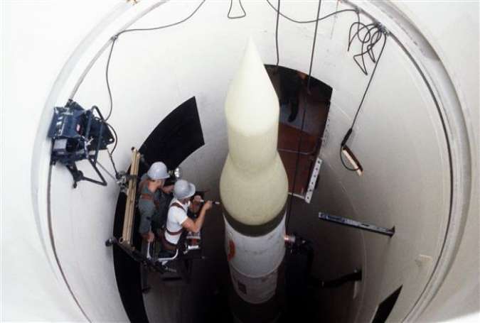 Two missile maintenance crewmen perform an electrical check on an LGM-30F Minuteman III intercontinental ballistic missile in its silo, January 1, 1980. (USAF photo)