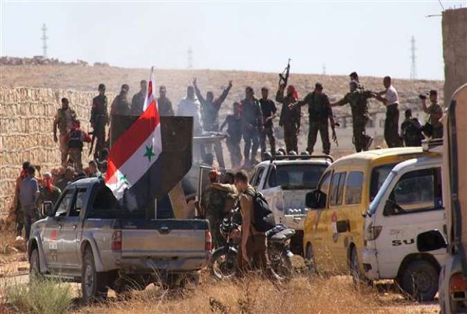 Syrian government forces celebrate after victory against terrorists