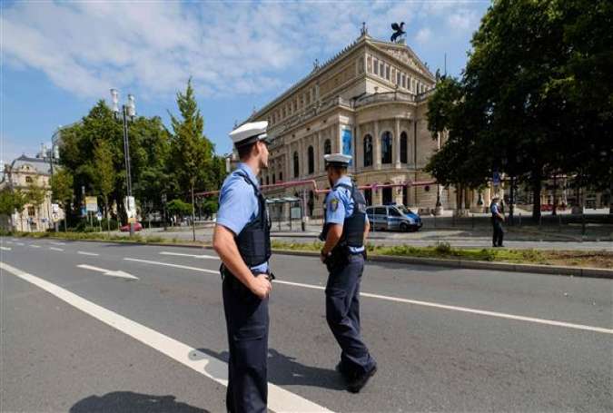 Police officers stand in a deserted street in front of the 
