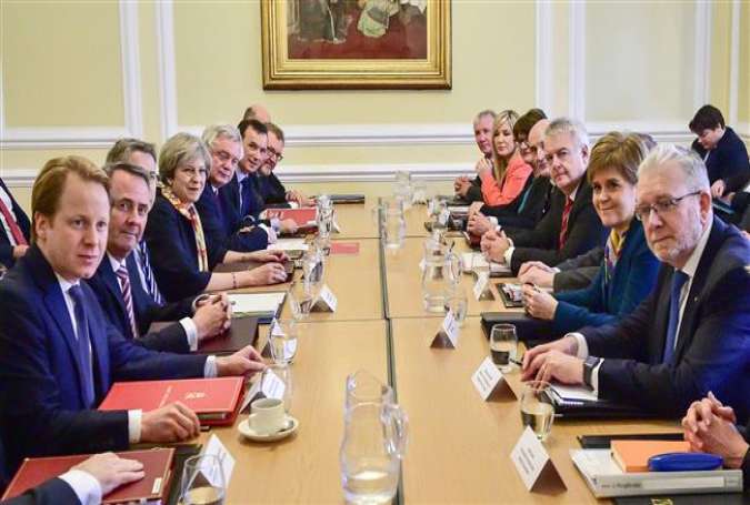 British Prime Minister Theresa May (4L) sits alongside members of her Cabinet as she prepares to chair a Joint Ministerial Committee at Cardiff City Hall in Cardiff on January 30, 2017, with Democratic Unionist Party (DUP) leader and Outgoing Northern Ireland First Minister, Arlene Foster (6R), Welsh First Minister Carwyn Jones (4R), and Scotland