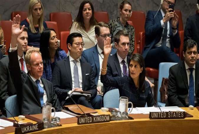 Matthew Rycroft, United Kingdom ambassador to the United Nations, and Nikki Haley (R), United States ambassador to the United Nations, raise their hands as they vote yes to levy new sanctions on North Korea during a meeting of the United Nations Security Council at UN headquarters, September 11, 2017, in New York City. (Photos by AFP)