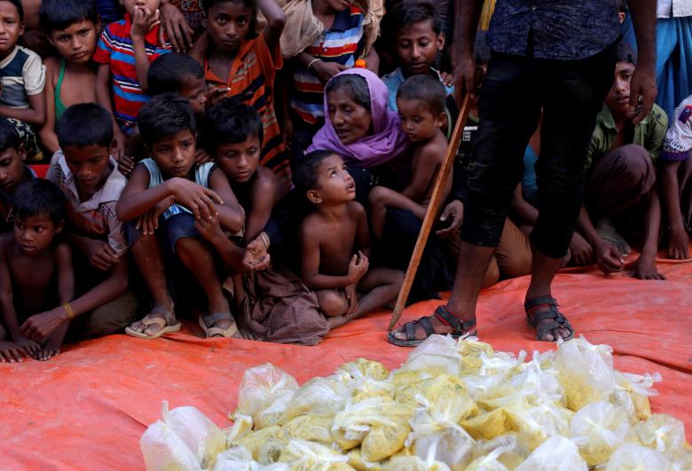 Rohingya refugees wait for the food to be distributed by local organisation outside a mosque in Cox's Bazar, Bangladesh.