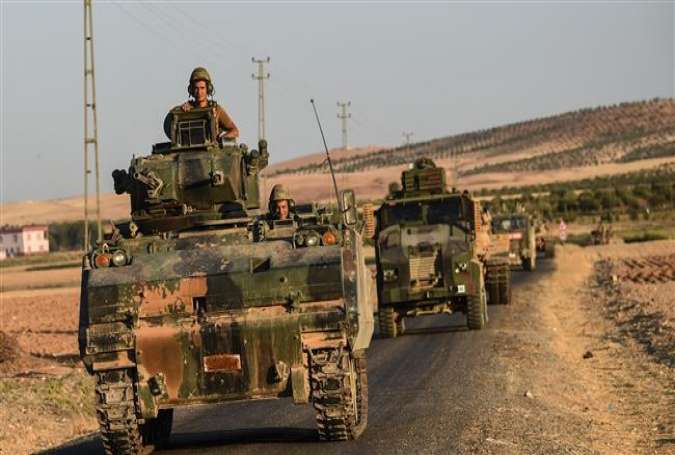 This file photo taken on September 02, 2016 shows Turkish soldiers standing in a Turkish army tank driving back to Turkey from the Syrian-Turkish border town of Jarabulus in the Turkish-Syrian border town of Karkamis. (Photo by AFP)