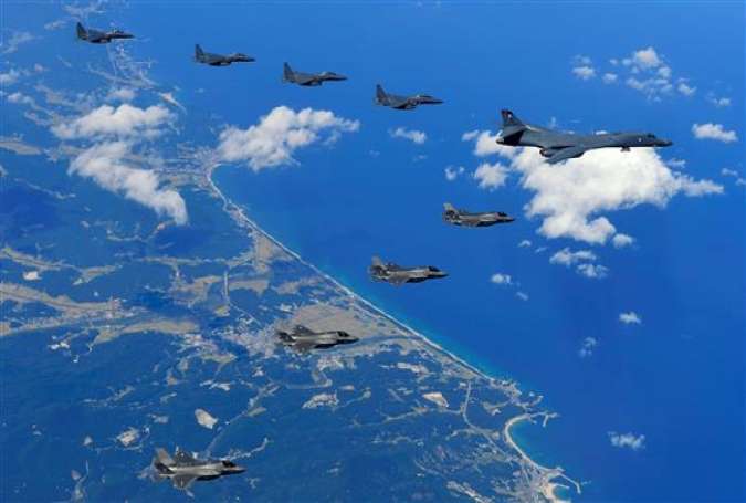 This handout photo taken on September 18, 2017 and provided by the South Korean Defense Ministry in Seoul shows a US Air Force B-1B Lancer bomber (R), US F-35B stealth jet fighters (bottom) and South Korean F-15K fighter jets (top) flying over South Korea. (Via AFP)