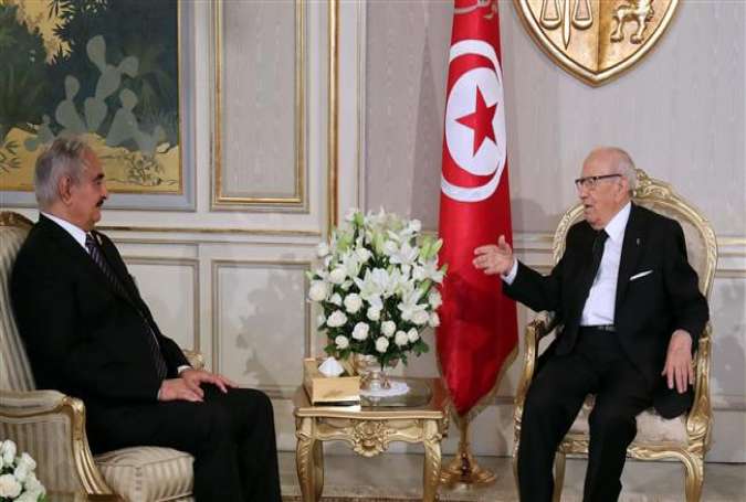 A handout picture released by the Tunisian Presidency Press Service shows Tunisian President Beji Caid Essebsi (R) meeting with Libyan General Khalifa Haftar on September 18, 2017 at Carthage Palace in Tunis. (Photo by AFP)