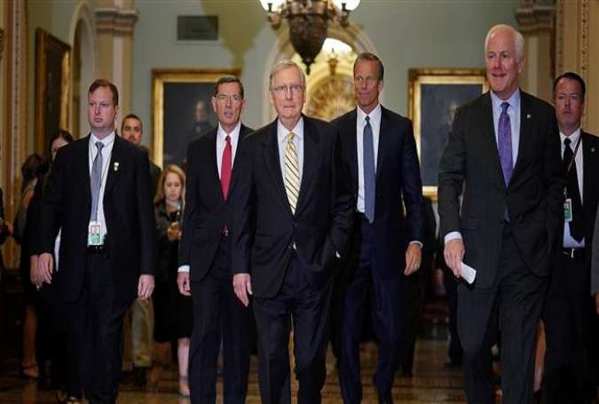 US Senate Majority Leader Mitch McConnell (R-KY) (C) walks with members of the Senate Republican leadership before answering questions at the US Capitol on September 12, 2017 in Washington, DC. (Photo by AFP)