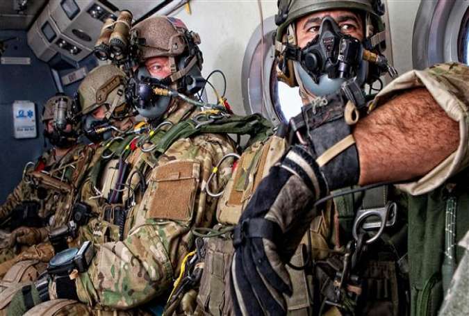 US Special Forces soldiers (Green Berets), wearing oxygen apparatus and with night vision goggles mounted on their helmets, prepare to conduct a high-altitude freefall parachute jump. (Photo via US Army)