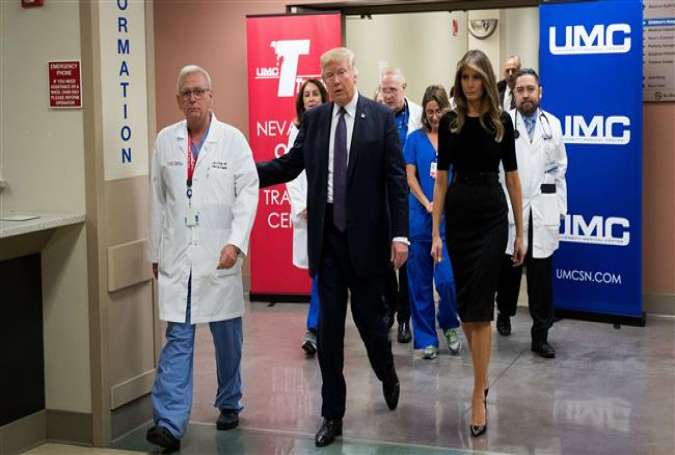 (L-R) Surgeon Dr. John Fildes, President Donald Trump and first lady Melania Trump walk together at University Medical Center, October 4, 2017 in Las Vegas, Nevada. (Photo by AFP)