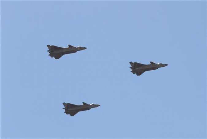 Chinese J-20 stealth fighter jets fly past during a military parade at the Zhurihe training base in China
