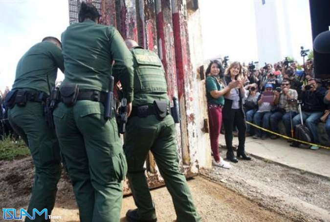 Border Patrol agents open a gate at the US-Mexico border November 18, 2017 in San Ysidro, California