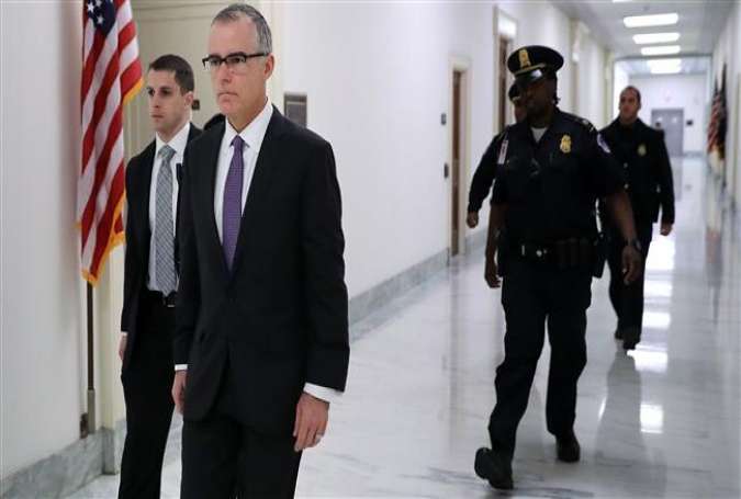 US Federal Bureau of Investigation Deputy Director Andrew McCabe (2nd L) is escorted by US Capitol Police before a meeting with members of the Oversight and Government Reform and Judiciary committees in the Rayburn House Office Building December 21, 2017 in Washington, DC. (Photo by AFP)