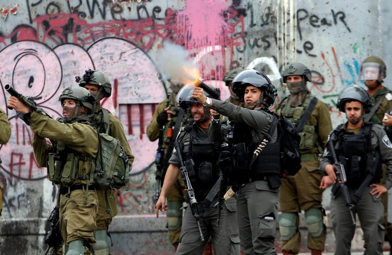 Israeli forces fire towards Palestinians during clashes in the West Bank city of Bethlehem, December 20.