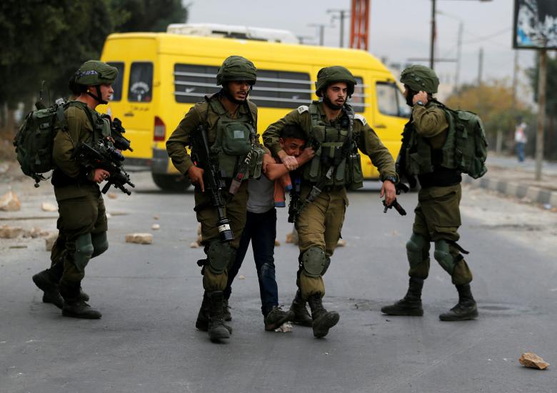 Israeli soldiers detain a Palestinian during clashes at a protest near the West Bank city of Nablus, December 20.