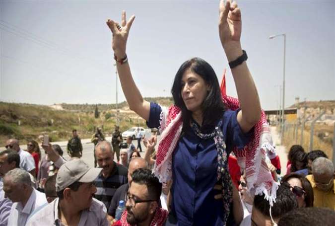 Prominent Palestinian lawmaker, Khalida Jarrar, flashes the sign for victory as she is lifted up by supporters at the Jubara checkpoint near the northern West Bank city of Tulkarem, following her release from an Israeli jail on June 3, 2016, after serving a 15-month sentence. (Photo by AFP)