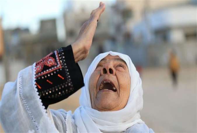 Palestinian woman reacts on a street in Beit Hanun in the northern Gaza Strip.jpg