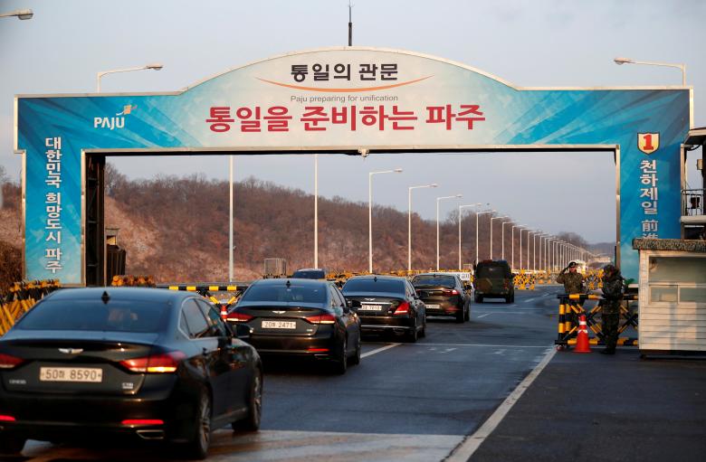 Vehicles transporting the South Korean delegation led by Cho Myoung-gyon, Minister of South Korean Unification Ministry, drive past a checkpoint on the Grand Unification Bridge that leads to the truce village of Panmunjom, just south of the demilitarized