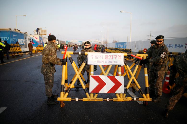 South Korean soldiers set up a barricade after vehicles transporting the South Korean delegation led by Cho Myoung-gyon, Minister of South Korean Unification Ministry, drove past a checkpoint on the Grand Unification Bridge that leads to the truce villag