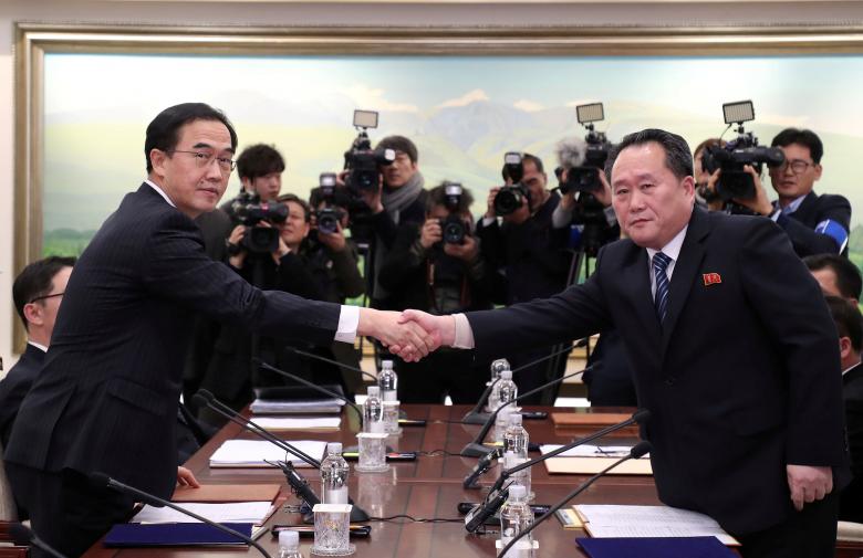 Head of the North Korean delegation, Ri Son Gwon shakes hands with South Korean counterpart Cho Myoung-gyon as they exchange documents after their meeting at the truce village of Panmunjom in the demilitarized zone separating the two Koreas, South Korea.