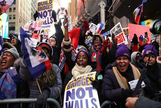 Hundreds of people, many of them Haitian, demonstrate against racism in Times Square on Martin Luther King (MLK) Day on January 15, 2018 in New York City. (Photo by AFP)