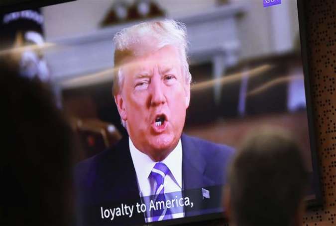 US President Donald Trump addresses new American citizens on a taped video shown at a naturalization ceremony on January 22, 2018 in Newark, New Jersey. (Photo by AFP)