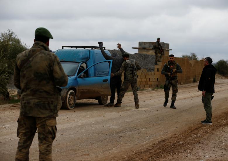Turkey-backed Free Syrian Army fighters are pictured at a check point in Azaz, Syria.