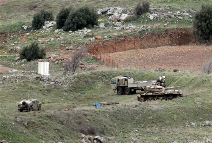 A picture taken on February 11, 2018 shows Israeli military vehicles deployed in the Israeli-occupied Golan Heights near Syria. (Photo by AFP)