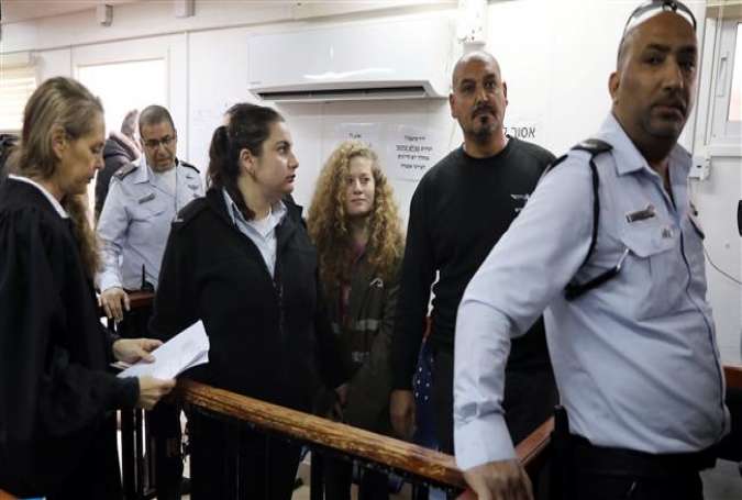 Palestinian teen Ahed Tamimi enters a military courtroom escorted by Israeli security personnel at Ofer Prison, near the West Bank city of Ramallah, February 13, 2018. (Photo by Reuters)