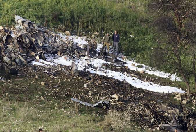 The remains of an F-16 Israeli war plane are seen near the village of Harduf, occupied Palestinian territories,