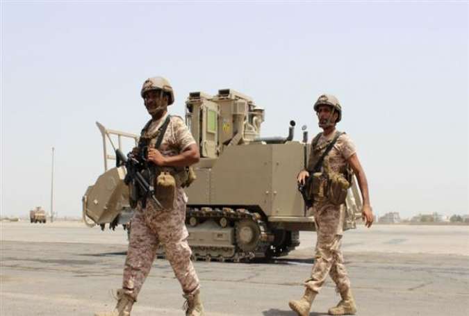 In this file picture, soldiers from the United Arab Emirates walk past a military vehicle at the airport of Yemen