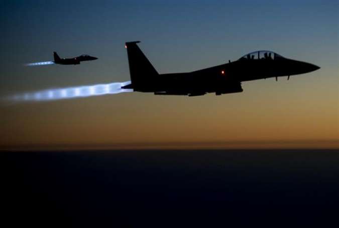 The file photo taken by the US Air Forces Central Command shows a pair of US Air Force F-15E warplanes flying over northern Iraq after conducting airstrikes in Syria. (Photo by AFP)
