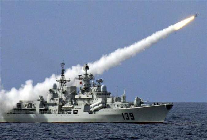 A file photo of a Chinese warship launching a ballistic missile that can strike targets nearly 2,000 miles away (by AP)