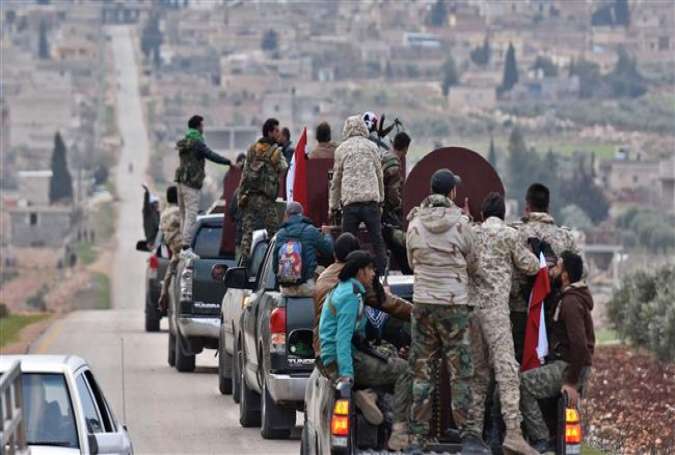 The photo shows a convoy of pro-Syrian government fighters arriving in Syria