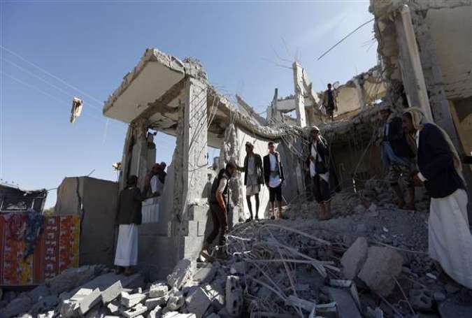 Yemenis check the damage in the aftermath of a reported airstrike in the Yemeni capital Sana