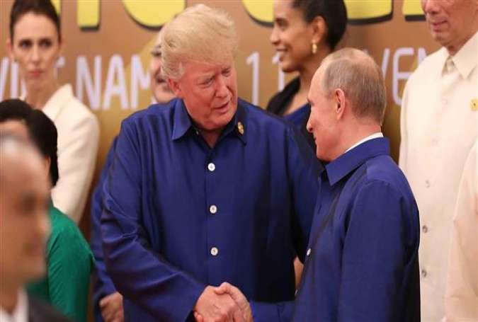 US President Donald Trump and Russian President Vladimir Putin shake hands at the Asia-Pacific Economic Cooperation (Apec) summit dinner in Vietnam last year. (Photo by Reuters)