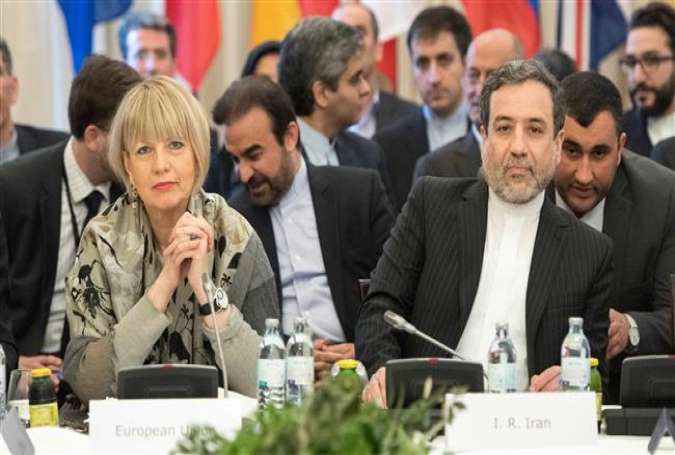Iranian Deputy Foreign Minister for Political Affairs Abbas Araqchi (R) and the Secretary General of the European Union External Action Service (EEAS) Helga Schmid (L) attend a meeting among the JCPOA signatories at Palais Coburg in Vienna, Austria, on March 16, 2018. (Photo by AFP)
