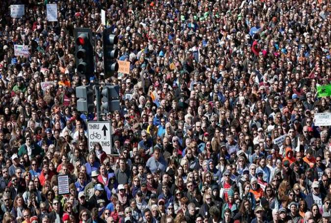 Gun reform advocates line Pennsylvania Avenue while attending the March for Our Lives rally March 24, 2018 in Washington, DC. (Photo by AFP)