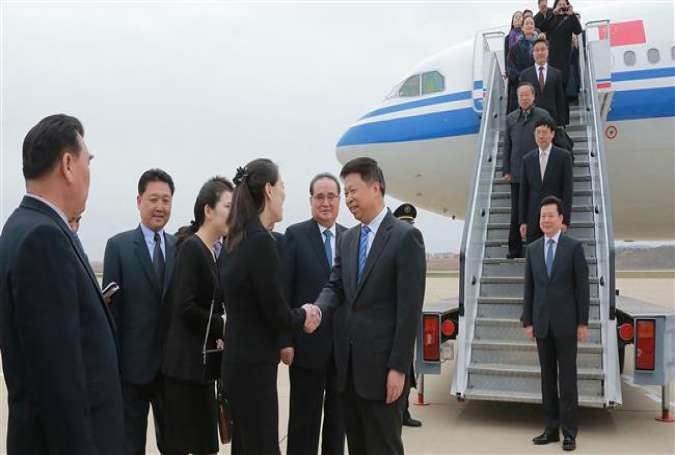 This picture, released by North Korea’s official KCNA news agency on April 14, 2018, shows Kim Yo-jong (4th-L), the North Korean leader’s sister, greeting Song Tao (centere-R), a senior Chinese diplomat, accompanied by a Chinese art troupe, on their arrival in the North Koran capital, Pyongyang. (Via AFP)