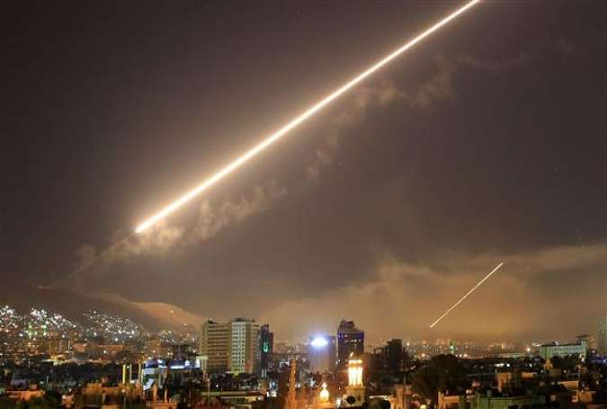 Damascus skies erupt with surface-to-air missile fire as the United States launches an attack on Syria targeting different parts of the Syrian capital Damascus early April 14, 2018. (Photo by AP)
