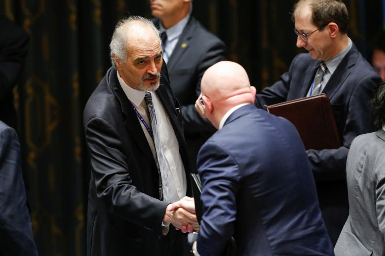 Bashar Jaafari, permanent Representative of the Syrian Arab Republic to the United Nations, shakes hands with Russian Ambassador to the United Nations Vasily Nebenzya at the end of the emergency United Nations Security Council meeting on Syria at the U.N