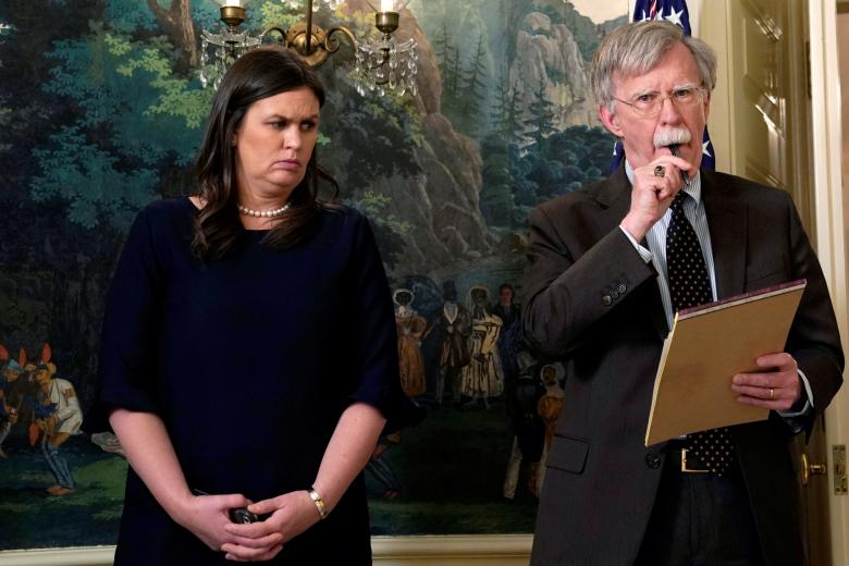 New National Security Adviser John Bolton and White House Press Secretary Sarah Huckabee Sanders listen to U.S. President Donald Trump's statement on Syria at the White House in Washington, April 13, 2018.