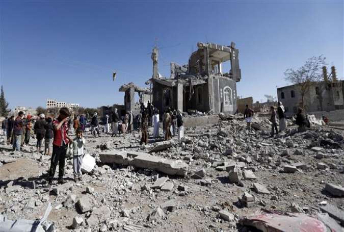 Yemenis check the damage in the aftermath of a Saudi airstrike in the Yemeni capital, Sana