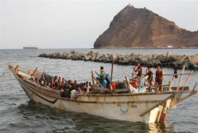 File photo shows illegal African migrants sitting on a boat off the southern Yemeni port city of Aden.