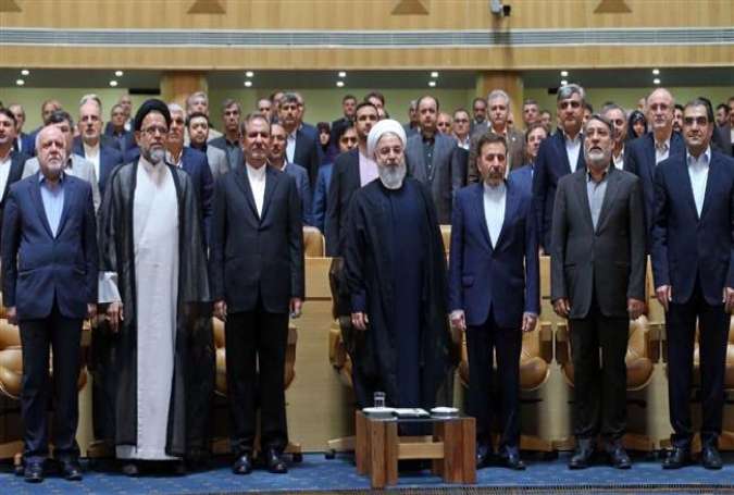 President Hassan Rouhani (C) and a number of his cabinet members and state officials stand for the national anthem being played during a gathering in Tehran, April 21, 2018. (Photo by IRNA)