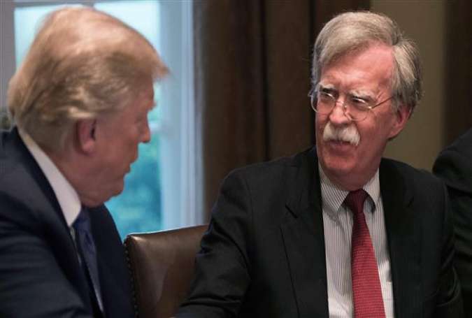 In this file photo taken on April 9, 2018, US President Donald Trump shakes hands with National Security Adviser John Bolton during a meeting with senior military leaders at the White House in Washington, DC. (AFP photo)