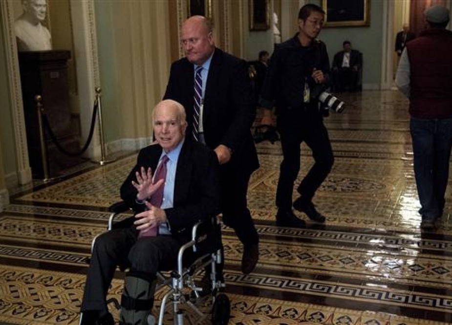 This file photo shows Senator John McCain (R-AZ) using a wheelchair on Capitol Hill on December 1, 2017. (By AFP)